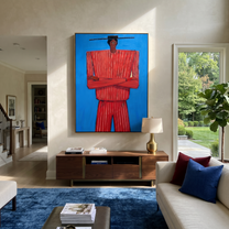Blue Holds Crimson Still – Crossed Arm Red Figure painting by Adrian Lee, mid-century modern vertical wall art – styled room scene view 2