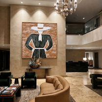 White Brim Frames Forest - Green Dress Hat Figure painting by Adrian Lee, mid-century modern square wall art – styled room scene view 5