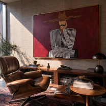 Burgundy Silence Crosses Black Lines - Striped Seated Hat Figure painting by Adrian Lee, mid-century modern horizontal wall art – styled room scene view 2