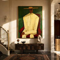 Ivory Robe Takes the Red Chair - Seated Ivory Robe Figure painting by Adrian Lee, mid-century modern vertical wall art – styled room scene view 2