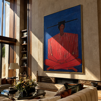 Scarlet Stripes Rest on Cobalt - Seated Red Stripe Figure painting by Adrian Lee, mid-century modern vertical wall art – styled room scene view 1