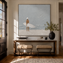 Quiet Surf Finds the Gray Sky - Minimal Surfer on Pale Beach painting by Claire Whitmore, modern coastal square wall art – styled room scene view 3