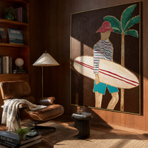 Coral Stripes Carry the Board - Surfer beside a Night Palm painting by Claire Whitmore, modern coastal vertical wall art – styled room scene view 4