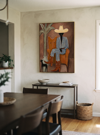 Striped Cowboy Keeps Watch - striped cowboy with dog painting by Claire Whitmore, modern coastal vertical wall art – styled room scene view 11