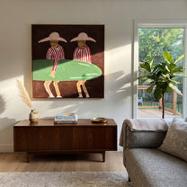 Green Board Crosses Burgundy - surfboard figure pair painting by Claire Whitmore, modern coastal square wall art – styled room scene view 1