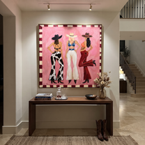 Three Cowgirls Claim Pink - three cowgirls on pink painting by Savannah Reed, modern folk art square wall art – styled room scene view 4