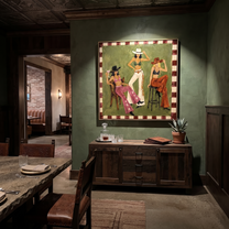 Green Room Holds Three - three cowgirls lounge painting by Savannah Reed, modern folk art square wall art – styled room scene view 5