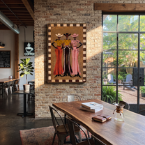 Three Hats Hold Ground - three cowgirls full-length painting by Savannah Reed, modern folk art vertical wall art – styled room scene view 4