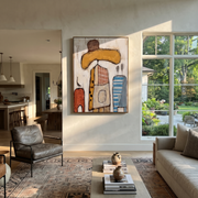 Ochre Brim Meets Blue - abstract cowboy figure painting by Savannah Reed, modern folk art vertical wall art – styled room scene view 1