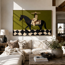 Harlequin Road Carries Her – Olive Cowgirl on Black Horse painting by Isabelle Laurent, modern Western horizontal wall art – styled room scene view 1