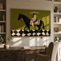 Harlequin Road Carries Her – Olive Cowgirl on Black Horse painting by Isabelle Laurent, modern Western horizontal wall art – styled room scene view 5