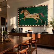 Emerald Spots Run Free – Patterned Gold Horse painting by Isabelle Laurent, modern Western horizontal wall art – styled room scene view 2
