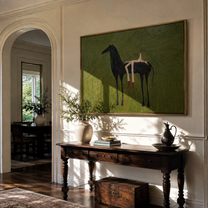 Olive Field Stretches Wide – Black Horse and Red Boots painting by Isabelle Laurent, modern Western horizontal wall art – styled room scene view 1