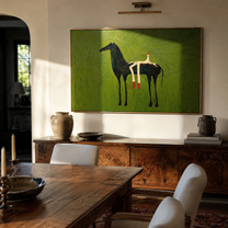 Olive Field Stretches Wide – Black Horse and Red Boots painting by Isabelle Laurent, modern Western horizontal wall art – styled room scene view 2