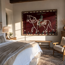 Burgundy Bones Keep Time – Striped Rider on Skeleton Horse painting by Isabelle Laurent, modern Western horizontal wall art – styled room scene view 1