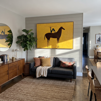 Still Hooves Meet the Open Sky - horse and rider painting by Isabelle Laurent, modern Western horizontal wall art – styled room scene view 5