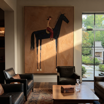 Long Mane Follow the Dust Road - horse and rider painting by Isabelle Laurent, modern Western vertical wall art – styled room scene view 1