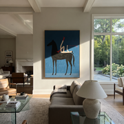 Painted Saddle Rise into Light - symbolic horse and rider painting by Isabelle Laurent, modern Western vertical wall art – styled room scene view 1