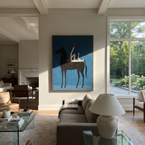 Painted Saddle Rise into Light - symbolic horse and rider painting by Isabelle Laurent, modern Western vertical wall art – styled room scene view 1