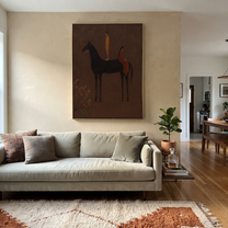 Amber Figure Rides into Umber - dark horse and rider painting by Isabelle Laurent, modern Western vertical wall art – styled room scene view 4