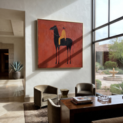 Ochre Rides through the Red Room - black horse rider painting by Isabelle Laurent, modern Western square wall art – styled room scene view 1