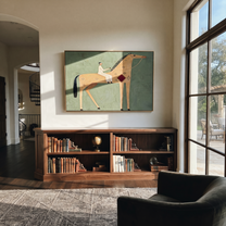 The Pale Rider Crosses the Sage Horizon - tan horse rider painting by Isabelle Laurent, modern Western horizontal wall art – styled room scene view 1