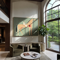 The Pale Rider Crosses the Sage Horizon - tan horse rider painting by Isabelle Laurent, modern Western horizontal wall art – styled room scene view 3