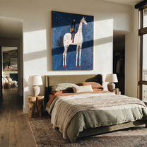 White Spots Rise through the Blue Night - spotted horse rider painting by Isabelle Laurent, modern Western vertical wall art – styled room scene view 1