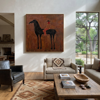 Rust Rider Waits on the Black Horse - cowgirl and black horse painting by Isabelle Laurent, modern Western square wall art – styled room scene view 4