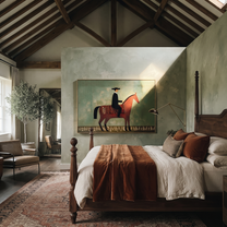 Black Hat Rides the Red Horse through Sage - red horse rider painting by Isabelle Laurent, modern Western horizontal wall art – styled room scene view 3