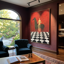 Red Boots Cross Checks - black horse and figure painting by Isabelle Laurent, modern Western vertical wall art – styled room scene view 4