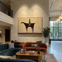 Long Rein Crosses Ivory - minimal horse rider painting by Isabelle Laurent, modern Western horizontal wall art – styled room scene view 5