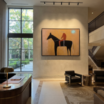Pale Loop Finds Rider - black horse rider painting by Isabelle Laurent, modern Western horizontal wall art – styled room scene view 3