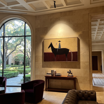 Wine Rises Above Black - black horse rider painting by Isabelle Laurent, modern Western horizontal wall art – styled room scene view 1