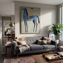 Blue Dapples Carry Gold - blue spotted horse rider painting by Isabelle Laurent, modern Western vertical wall art – styled room scene view 4