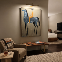 Blue Dapples Carry Gold - blue spotted horse rider painting by Isabelle Laurent, modern Western vertical wall art – styled room scene view 5
