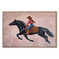 Cowgirl Gallops Through Blush - black horse cowgirl painting by Isabelle Laurent, modern Western horizontal wall art – wood frame on white background