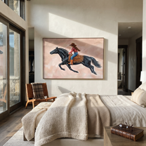 Cowgirl Gallops Through Blush - black horse cowgirl painting by Isabelle Laurent, modern Western horizontal wall art – styled room scene view 3