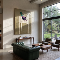 White Horse Carries Green - spotted white horse rider painting by Isabelle Laurent, modern Western vertical wall art – styled room scene view 2