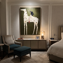 Brown Spots Carry Black - spotted white horse rider painting by Isabelle Laurent, modern Western vertical wall art – styled room scene view 4