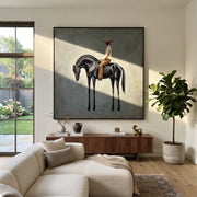 Black Horse Bows Blue - black horse rider painting by Isabelle Laurent, modern Western square wall art – styled room scene view 1
