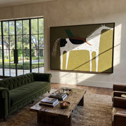 Green Rider Crosses Olive - spotted white horse painting by Isabelle Laurent, modern Western horizontal wall art – styled room scene view 1
