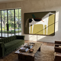 Green Rider Crosses Olive - spotted white horse painting by Isabelle Laurent, modern Western horizontal wall art – styled room scene view 1