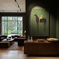 Mustard Reader Rides Green - black horse reader painting by Isabelle Laurent, modern Western vertical wall art – styled room scene view 3