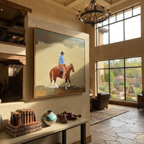 Dusty Trail Carries Home - cowboy trail horse painting by Isabelle Laurent, modern Western square wall art – styled room scene view 5