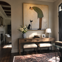 The Cat Looks Up – Green Figure and Cat painting by Hannah Brooks, minimalist figurative square wall art – styled room scene view 2