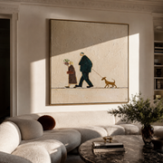 Three Share The Road – Walking Couple and Tan Dog painting by Hannah Brooks, minimalist figurative square wall art – styled room scene view 1