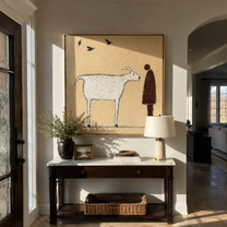 Birds Cross Their Meeting – White Goat and Brown Figure painting by Hannah Brooks, minimalist figurative square wall art – styled room scene view 1