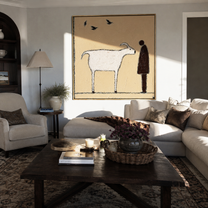 Birds Cross Their Meeting – White Goat and Brown Figure painting by Hannah Brooks, minimalist figurative square wall art – styled room scene view 4
