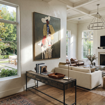 Four Hounds Follow Crimson - cowboy and four hounds painting by Hannah Brooks, minimalist figurative vertical wall art – styled room scene view 2